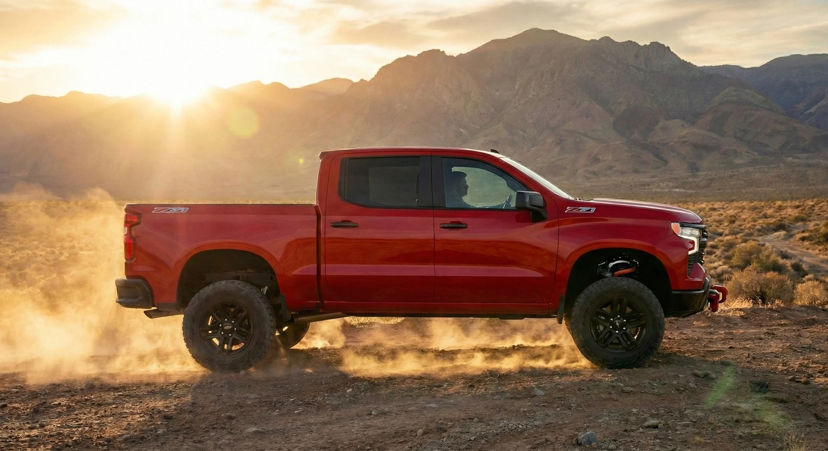 2026 Silverado Trail Boss side profile showing factory 2-inch lift, Goodyear Wrangler Territory tires, and blacked-out trim